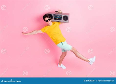 Photo Of Cheerful Relaxed Guy Dance Hold Boombox Radio Wear Yellow T