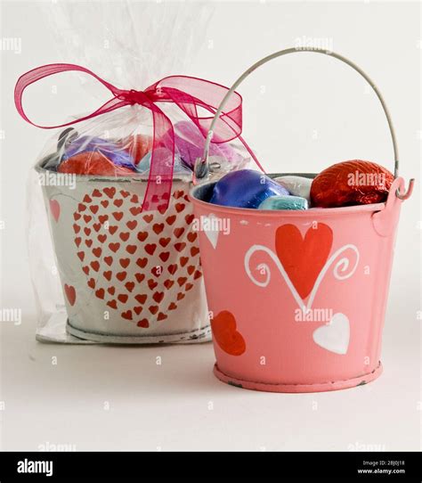 Small Buckets Decoratively Painted With Hearts Filled With Chocolates