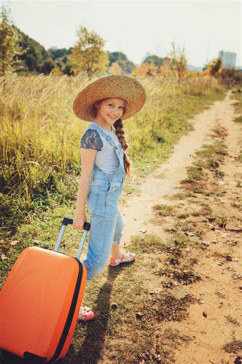 Happy Child Girl With Orange Suitcase Traveling Alone On Summer