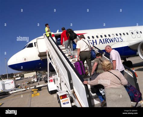 Passengers Boarding A British Airways Aircraft Via Steps Carrying Stock