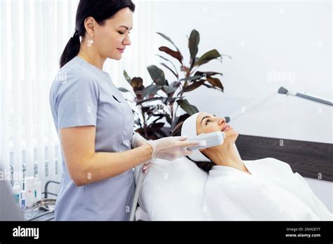 Portrait Of Relaxed Young Female Client Getting Smas Ultrasound Face