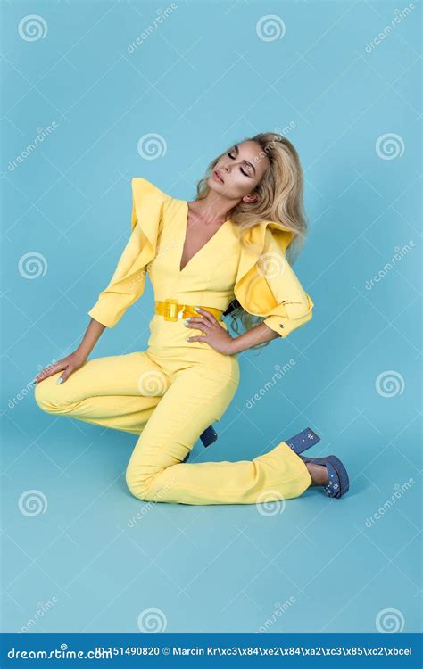 Elegant Blonde Woman In Stylish Yellow Jumpsuit And Fashionable