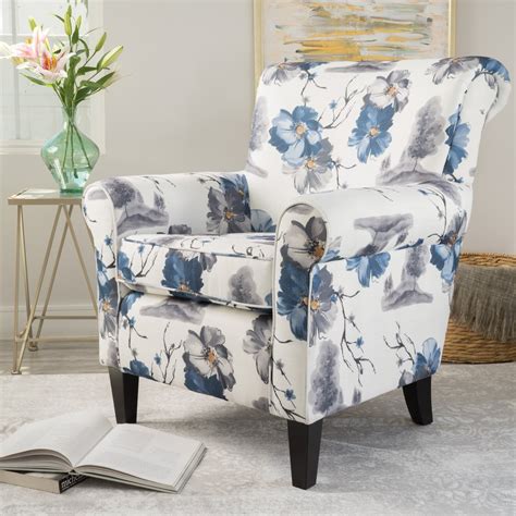 It is mounted on wooden legs. Manon Blue & White Floral Print Fabric Club Chair - GDF Studio