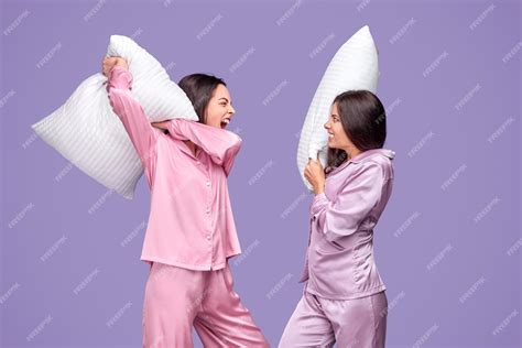 Premium Photo Young Women Having Pillow Fight During Sleepover