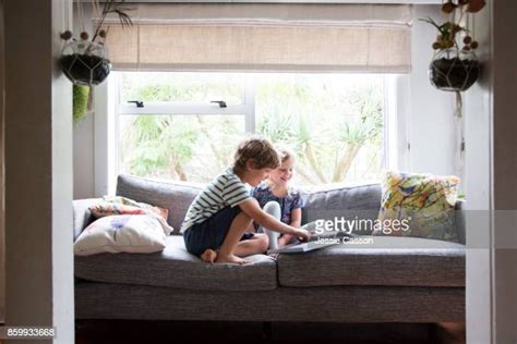 Brother And Sister Sitting On Couch Photos And Premium High Res Pictures Getty Images