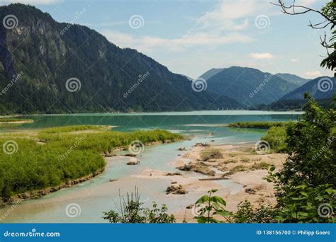 Idyllic Mountain Landscape With A River And Mountains In The Background