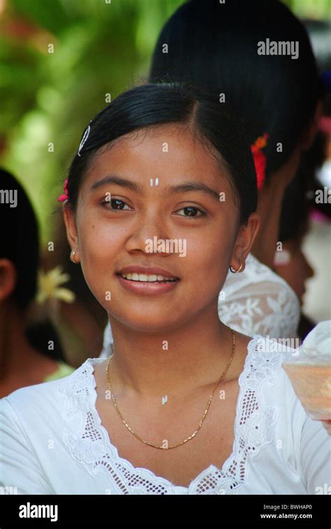 A Beautiful Balinese Woman Dressed In Traditional Clothing At A Temple Ceremony In The Village