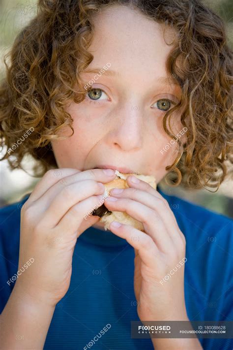 A Young Boy Eating A Sausage In A Bread Roll — Nature One Boy Only