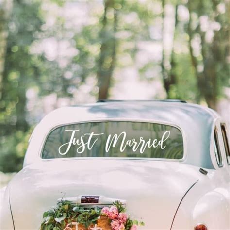 An Old Car Is Decorated With Flowers And The Words First Married On It