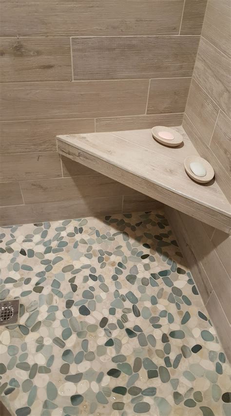 A crash course on installing pebble tile flooring. Stunning shower floor using Sliced Sea Green and White ...