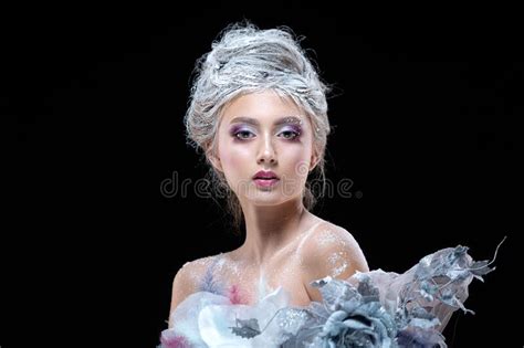 Winter Beauty Woman In Clothes Made Of Frozen Flowers Covered With