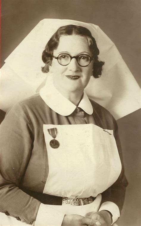 An Old Black And White Photo Of A Woman Wearing Glasses With A Apron