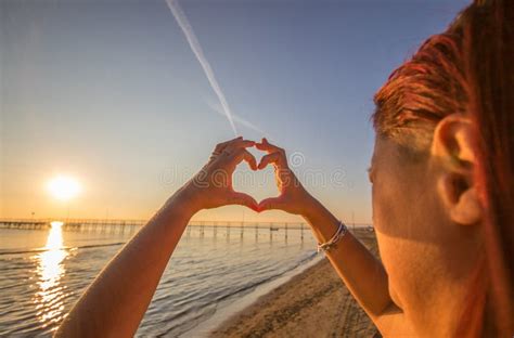 woman hands in heart symbol shaped with sunset light stock image image of people sunlight