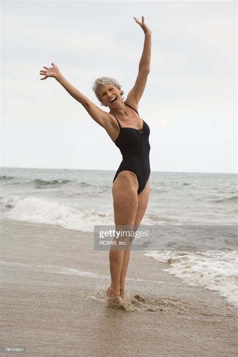 Middleaged Woman In Swimsuit At Beach Photo Getty Images