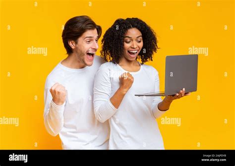 Online Betting Concept Joyful Interracial Couple Celebrating Win With