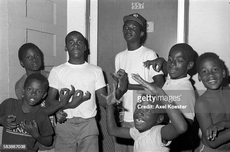 Young Boys And Members Of The Grape Street Crip Throwing Their