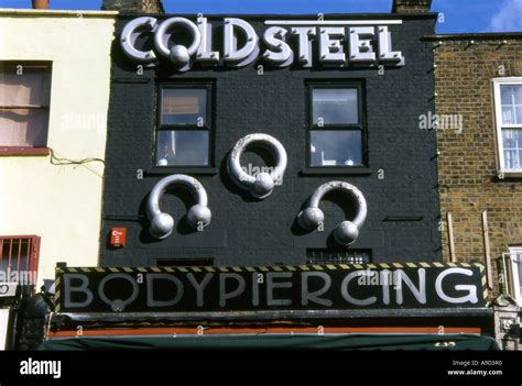 View Of Typical Colourful Body Piercing Shop In Camden Town London