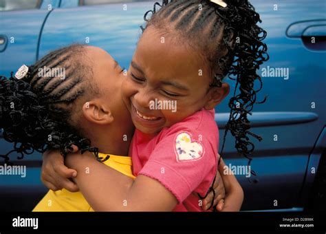 Twin Sisters Hugging Each Other Stock Photo Alamy