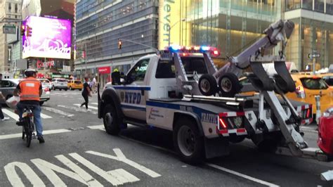 Nypd Tow Truck Towing A Car On 8th Avenue In The Hells Kitchen Area Of