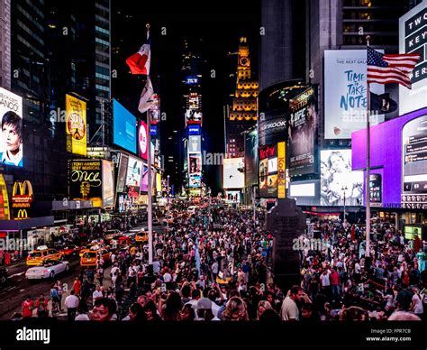 Crowd Of People In Times Square At Night New York City Usa Stock