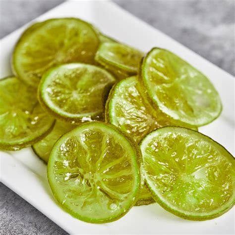 sliced limes on a white plate sitting on a table