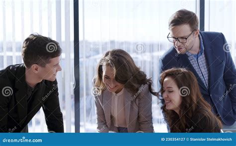 Diverse Group Of Young Office Workers Having Cheerful Conversation