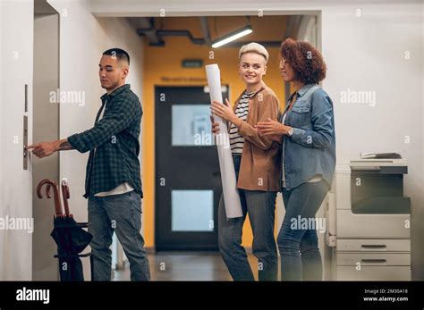 Group Of Three Office Workers Waiting For The Lift Stock Photo Alamy