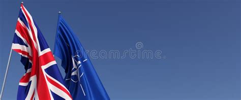 Flags Of The United Kingdom And Nato On Flagpoles On Side Flags On A