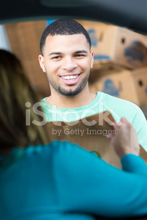 Man Accepting Bags Of Groceries From Woman At Food Bank Stock Photo Royalty Free Freeimages