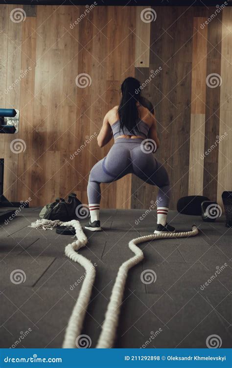 A Girl Athlete With A Pumped Up Booty Squats With A Phyto Ball Near The