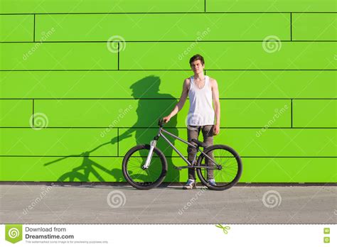 Boy With Silver Bike Stay At Green Wall Background Stock Photo Image