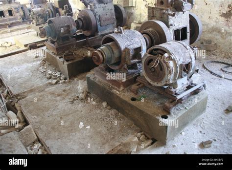 Old Damaged Machinery In Derelict Manufacturing Workshop Stock Photo