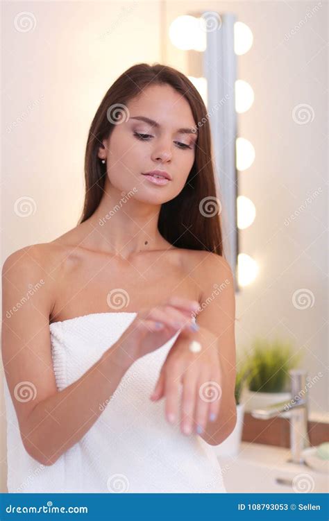 Attractive Young Woman Applying Cream On Her Face Stock Image Image