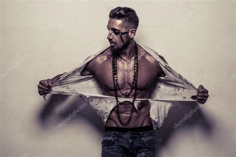 Muscular Man In Ragged Clothes Ripping Off His Shirt Stock Photo By