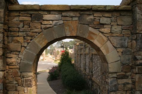Keystone Natural Stone Archway Leading To A Garden Walkway Or Home