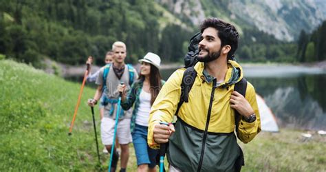 Group Of Friends Hiking Together Outdoors Exploring The Wilderness And