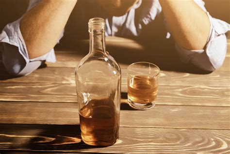A Person Drinking A Bottle Of Whiskey By Themselves Showing Signs Of