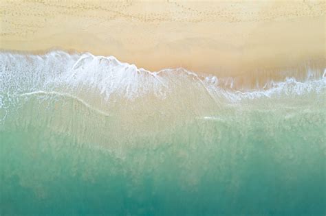Aerial View Of Turquoise Ocean Wave Reaching The Coastline Beautiful