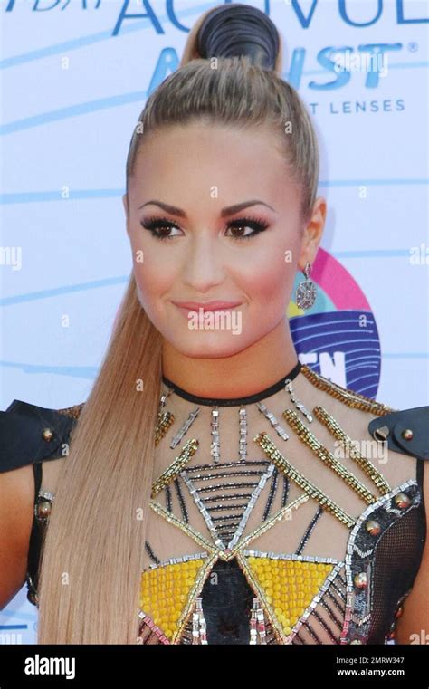 demi lovato wears a highly decorated dress complete with feathers at the 2012 teen choice awards