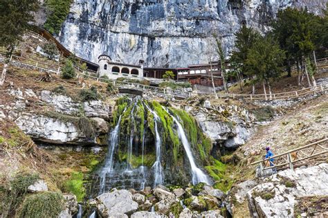 Tourist Looking At St Beatus Waterfall Beatenberg Canton Of Bern