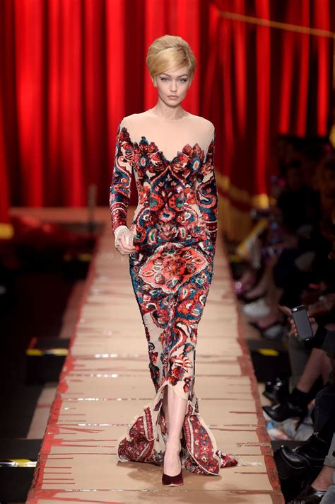 For the latest beauty and style trends. GIGI HADID at Moschino Fashion Show at Milan Fashion Week ...