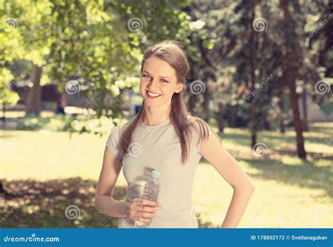 Mujer Sosteniendo Una Botella De Agua En Las Manos Sonriendo Mirando A