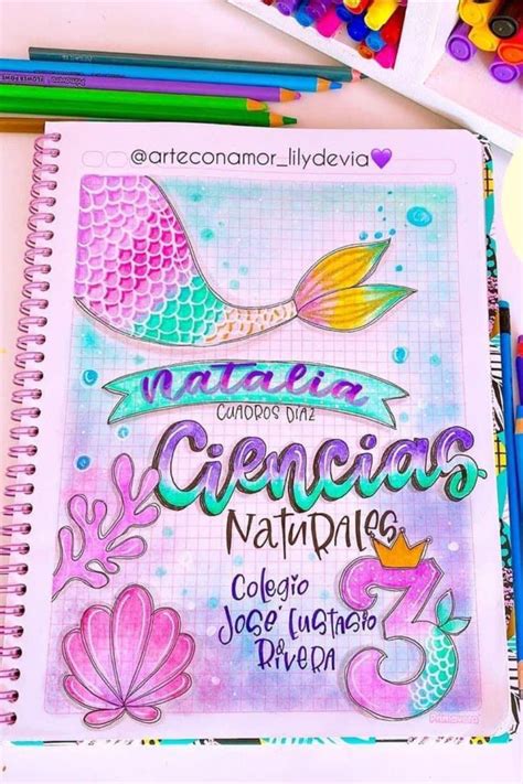 An Open Notebook With Mermaid Drawings On It And Colored Pencils Next