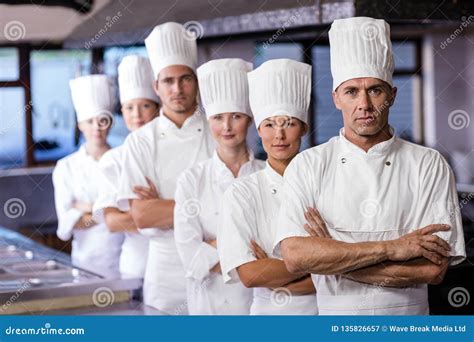 Group Of Chefs Formig Huddles In Kitchen Royalty Free Stock Photo