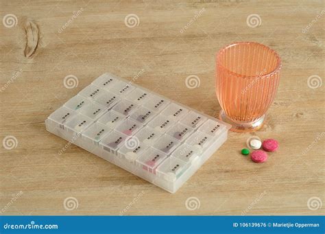 A Glass With Pills And A Pill Container Stock Photo Image Of