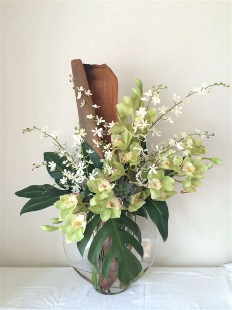 Cymbidium Orchids Lush Greenery And Palm Husk By Floral Instinct Corporate Flowers