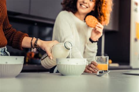 Young Woman Preparing Breakfast For Herself And Her Roommate Stock