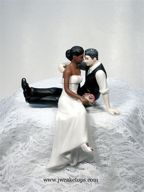 dark brown skin tone bride and caucasian groom with salt and pepper hair color wedding cake
