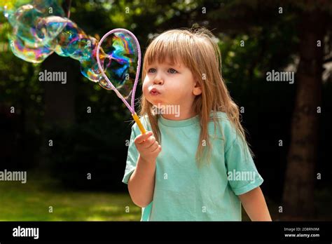 Little Child Girl Blowing Huge Bubbles Alone Portrait Outdoors Young