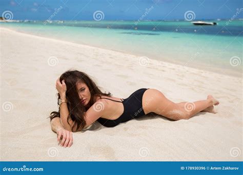 Beautiful Woman In Black Bikini Lies On The White Sand On The Beach Stock Photo Image Of
